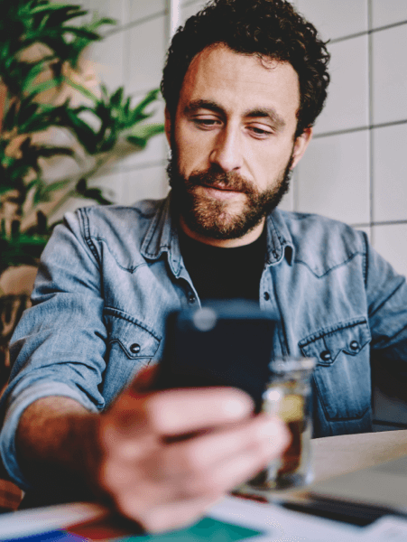 Someone using TotalAV&trade; on a mobile phone